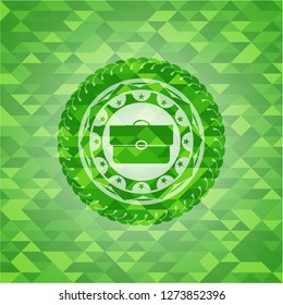 briefcase icon inside green emblem with mosaic ecological style background