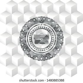 briefcase icon inside grey badge with geometric cube white background