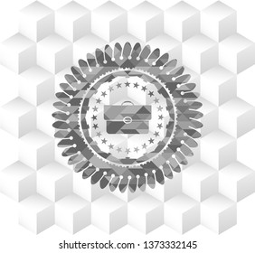 briefcase icon inside grey emblem with geometric cube white background