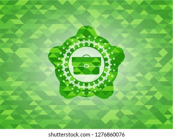 briefcase icon inside realistic green mosaic emblem