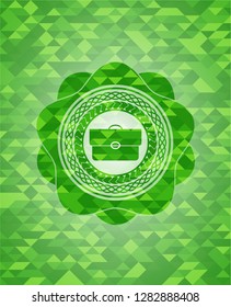 briefcase icon inside realistic green mosaic emblem