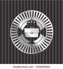 briefcase icon inside silver emblem or badge