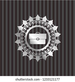 briefcase icon inside silvery emblem or badge