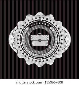 briefcase icon inside silvery emblem