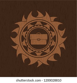 briefcase icon inside wooden emblem. Vintage.