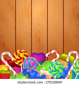Bright background with candies on wood