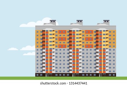 Bright big multi-storey townhouse with balconies on background of the light blue sky.