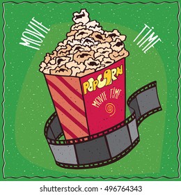 Bright cardboard box with heap of popcorn and reel of film. Cinema concept. Green background and lettering Movie time. Handmade cartoon style. Vector illustration