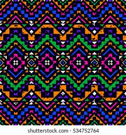 Bright colored seamless pattern with tribal aztec ornament and shabby effect.