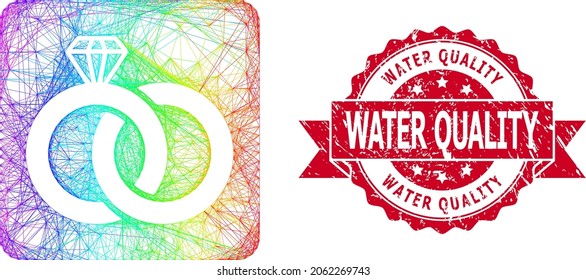 Bright colored wire frame diamond wedding rings, and Water Quality rubber ribbon stamp. Red stamp includes Water Quality text inside ribbon.