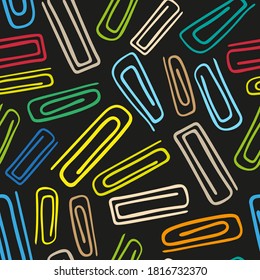 Bright colorful multicolored paper clips isolated on black background. Dark seamless pattern. Vector flat graphic hand drawn illustration. Texture.