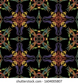 Bright colorful zigzag stitching embroidery style seamless pattern. Ornamental vector tapestry background. Floral grunge ornament with embroidered flowers, leaves, shapes. Textured ornate design.