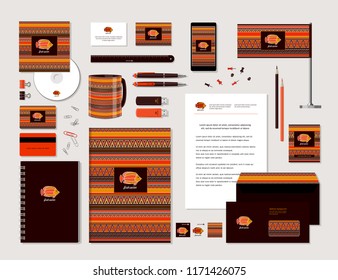 The bright corporate identity with fish and ornaments in ethnic style. Samples of business cards, a disk, a flag, a pen, a flash card, a form, an envelope, a mug, a notepad, a pencil. Vector.