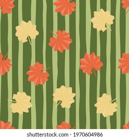 Bright decorative exotic yellow and orange leaves shapes seamless pattern in doodle style. Green striped background. Perfect for fabric design, textile print, wrapping, cover. Vector illustration.