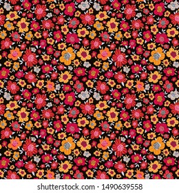 Bright floral print with rich red, yellow, orange small flowers on a dark background. Flowery folk print for fashion fabrics, Wallpaper,  interior design... National ethnic motives. Vector.