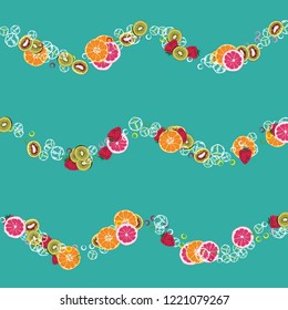 Bright fruity background with orange, grapefruit, strawberries and kiwi on a blue background.