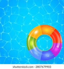 Bright inflatable ring floats in clear blue water. Colorful segments glow under sunlight's warmth. Water ripples show gentle, refreshing movement. Ideal for vacation, pool party, or summer fun. Copy space