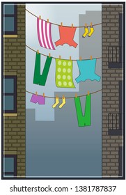 Bright laundry hangs from two city buildings.