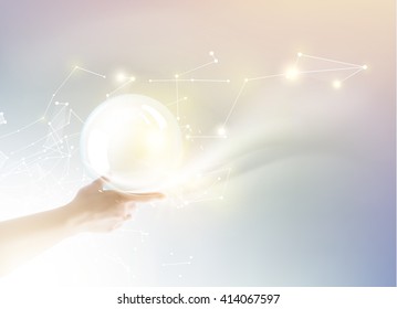 Bright light ball over human hand.