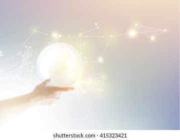 Bright light ball over human hand.