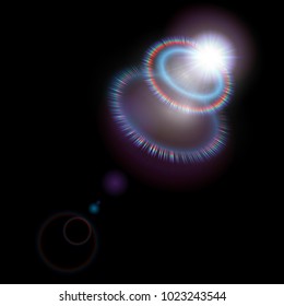Bright light effect of the lens flash. Iridescent rays and blurred highlights on a black background