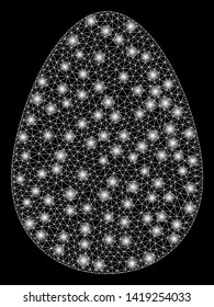 Bright mesh egg with lightspot effect. Abstract illuminated model of egg icon. Shiny wire frame polygonal mesh egg. Vector abstraction on a black background.