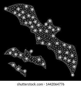 Bright mesh flying bats with glow effect. Abstract illuminated model of flying bats icon. Shiny wire carcass polygonal mesh flying bats abstraction in vector format on a black background.