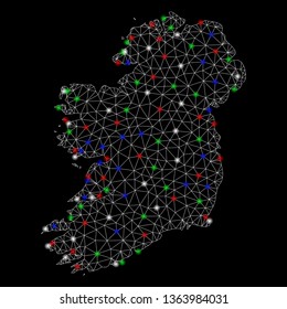 Bright mesh Ireland Island map with glare effect. Wire frame triangular mesh in vector format on a black background. Abstract 2d mesh designed with triangular lines, dots, colored flare spots.