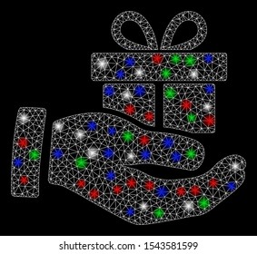 Bright mesh present box give hand with glare effect. White wire frame polygonal mesh in vector format on a black background. Abstract 2d mesh designed with triangular lines, points,