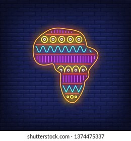 Bright motif in Africa map outline neon sign. Pattern, ethnic ornament, decor design. Night bright neon sign, colorful billboard, light banner. Vector illustration in neon style.