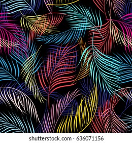 Bright multicolored pattern of leaves of palm trees on a dark background