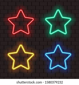Bright neon star frames for banner or sign isolated on a dark brick wall. Red, green, blue, yellow light.