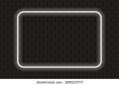 Bright neon white rectangle frame for banner or sign isolated on a dark brick wall.