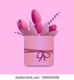Bright pink tulips in a square pot with a rope and a tiny bow. There are springs and leaves also.