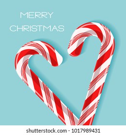 Bright poster with candy cane heart. Two red and white glossy realistic lollipops with shadow and text Merry Christmas isolated on spearmint color background. Vector design for card, tag, gift sticker