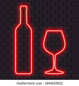 Bright red neon wine bottle and glass for banner or sign isolated on a dark brick wall.