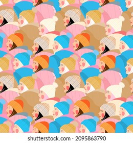 bright seamless pattern with the image of girls in knitted warm hats.