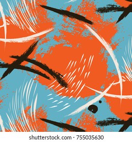 Bright seamless pattern with orange splashes on painted blue background. Abstract grunge painted texture with pastel ink splatter.