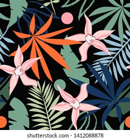 Bright seamless pattern with tropical leaves and plants on black background. Vector design. Jungle print. Textiles and printing.