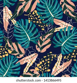 Bright seamless pattern with tropical leaves and plants on purple background. Vector design. Jungle print. Textiles and printing.