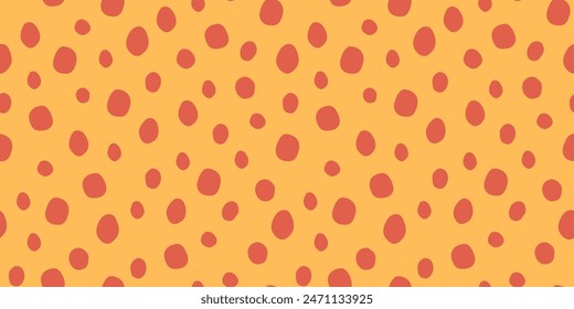 Bright seamless spotted pattern. Vector print from animal skin. Colorful illustration in yellow and orange colors. Hand-drawn figures in flat style.
