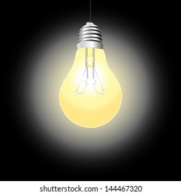 bright shining light bulb on a dark background