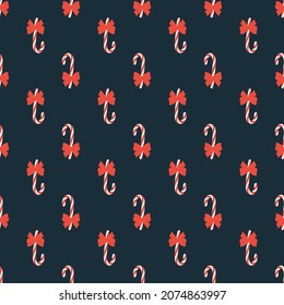 Bright simple cartoon Christmas seamless pattern with candy lollipop with red bow on blue background. Holiday floral hand drawn wrap paper or fabric design. Winter christmas decor in vector.