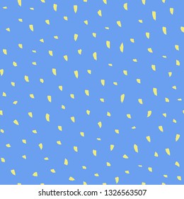 A bright, trendy blue and yellow animal spots print made with uneven brush strokes