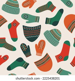 Bright trendy seamless pattern, winter warm clothes, socks, hats, mittens, white background, hand drawn, vector