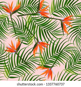 Bright tropical background. Palm leaves and bird of paradise (strelitzia) seamless pattern.