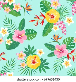 Bright tropical seamless pattern with tropical flowers on aquamarine background.