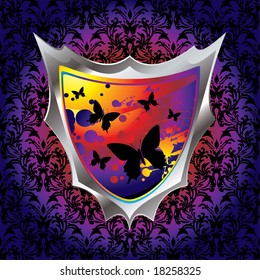 brightly coloured shield with butterfly and ink splats