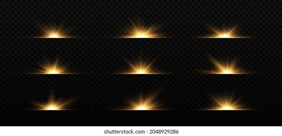 Brights golden flashes on black background. Shining stars, beautiful golden rays. Optical flares.