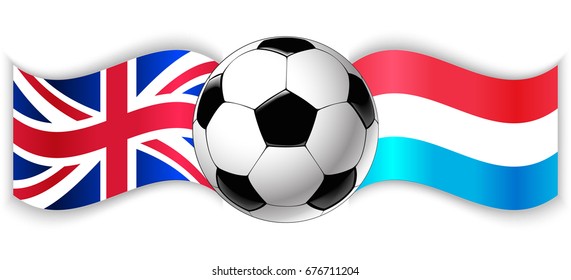 British and Luxembourgish wavy flags with football ball. United Kingdom combined with Luxembourg isolated on white. Football match or international sport competition concept.